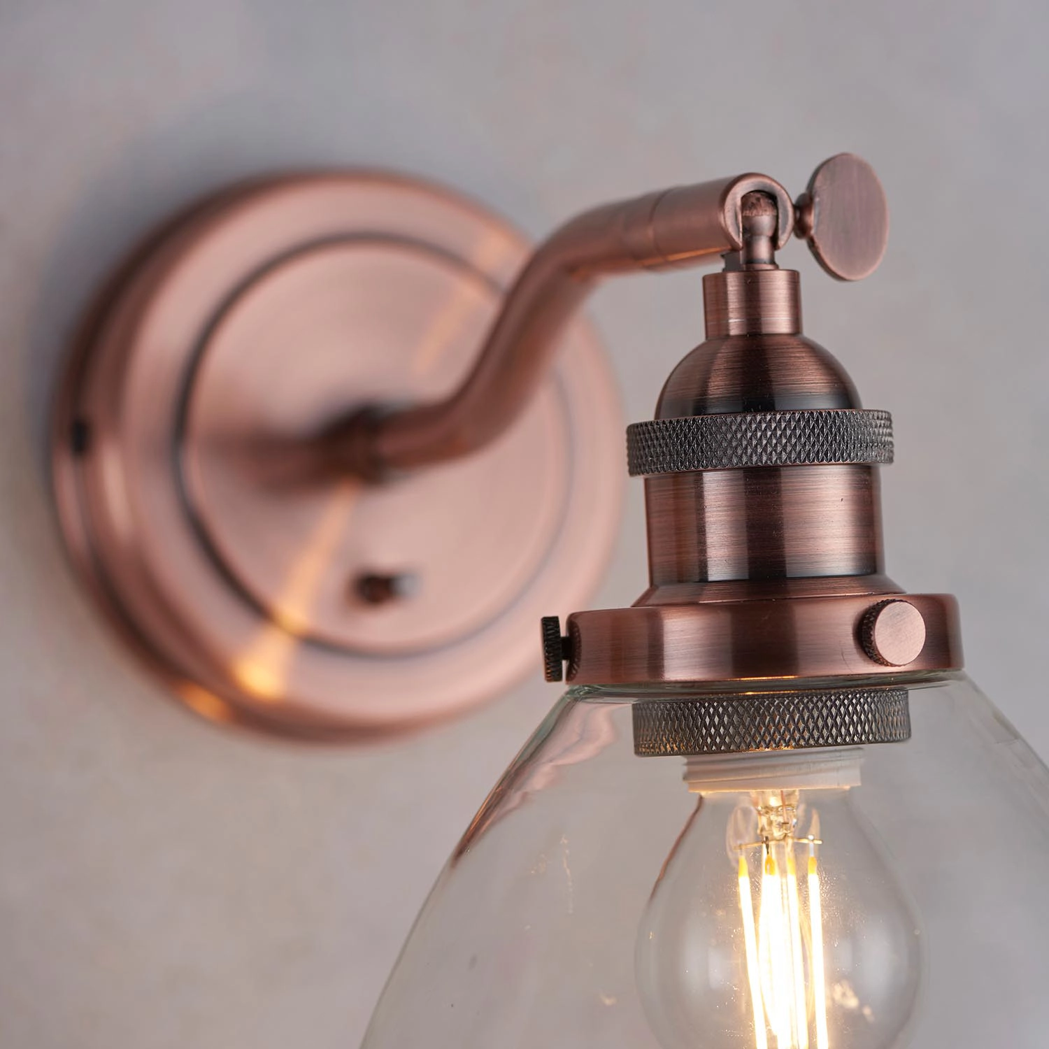 Zuri dimmable wall light in copper with knurled lamp holder and