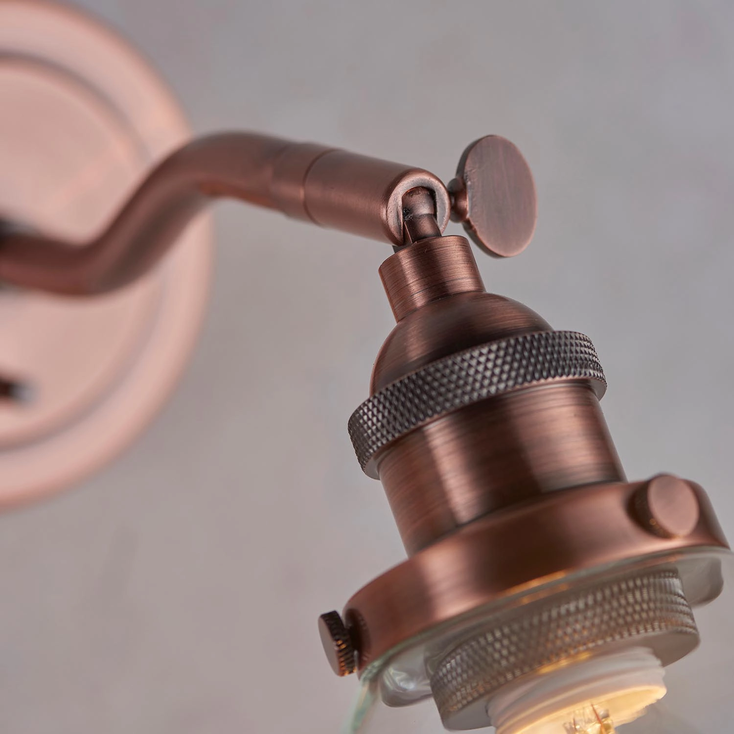 Zuri dimmable wall light in copper with knurled lamp holder and